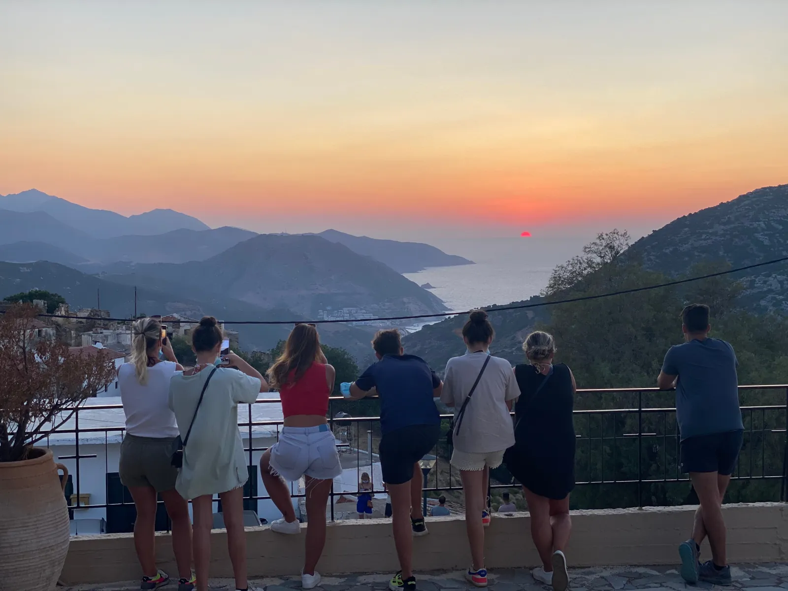 The group watching the sun set over the mountains and the coast