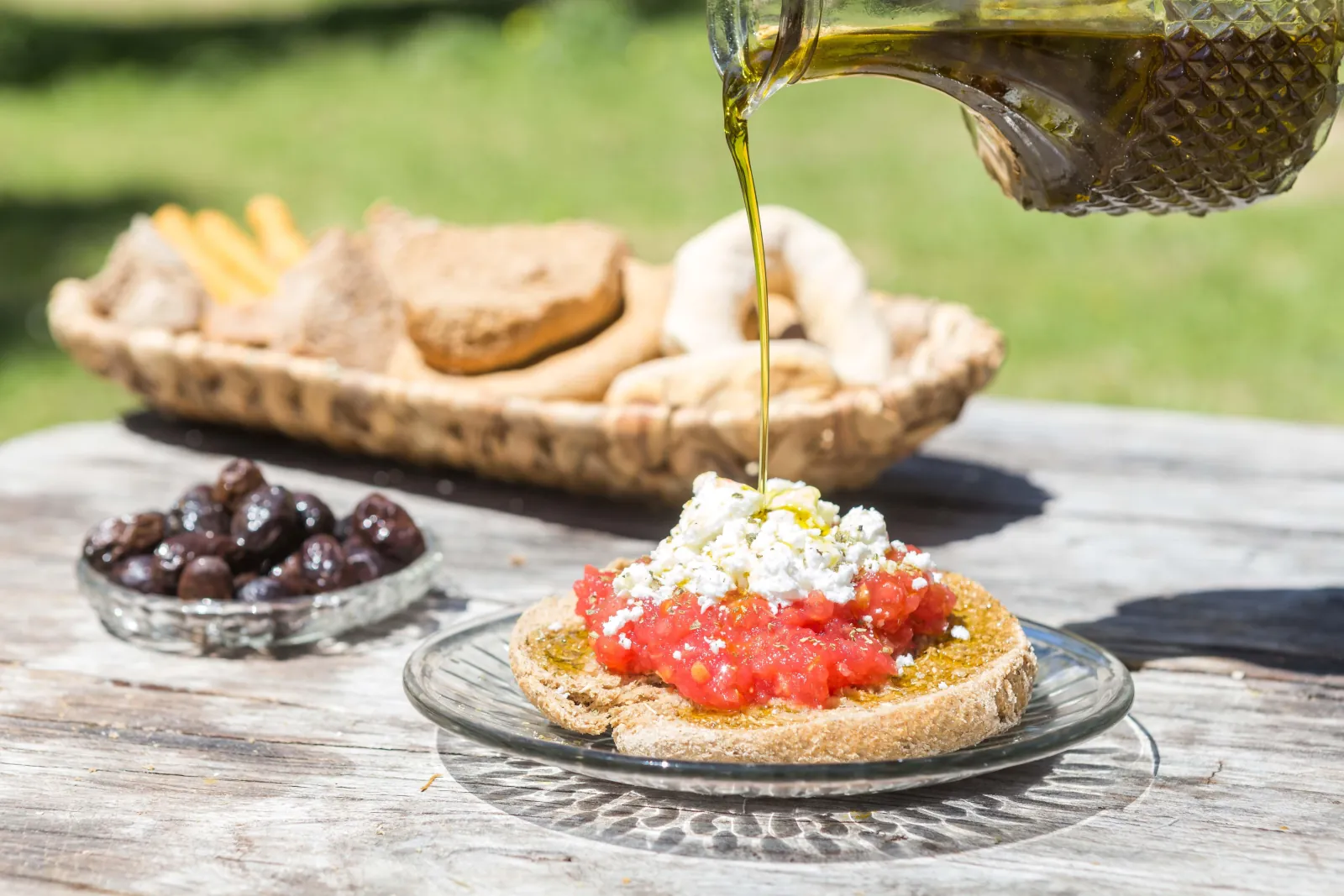 Cretan dakos — a barley rusk with tomato and cheese, dressed with oil
