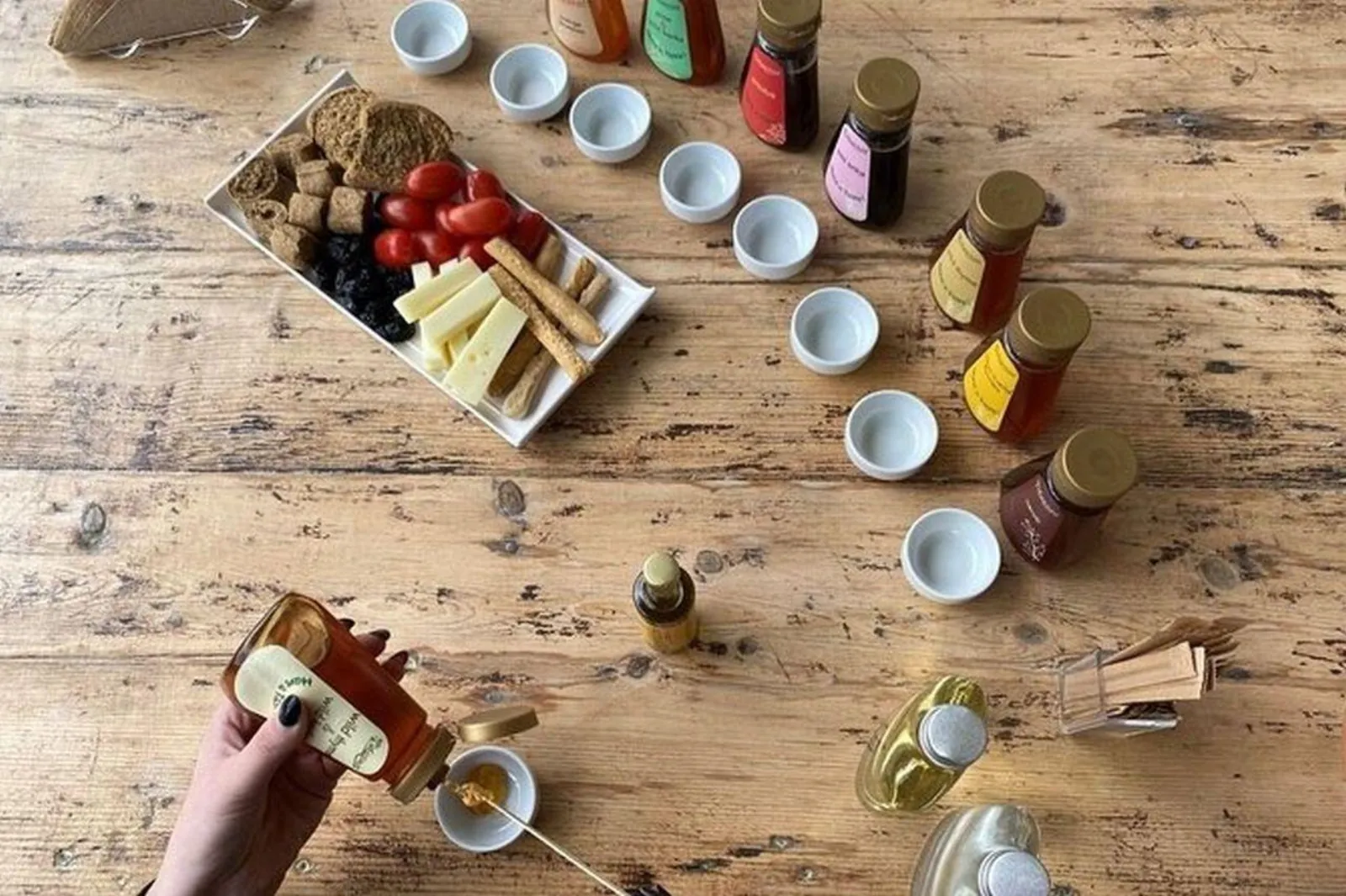 Tasting table laid with olive oils, cheese, tomatoes and Cretan rusks