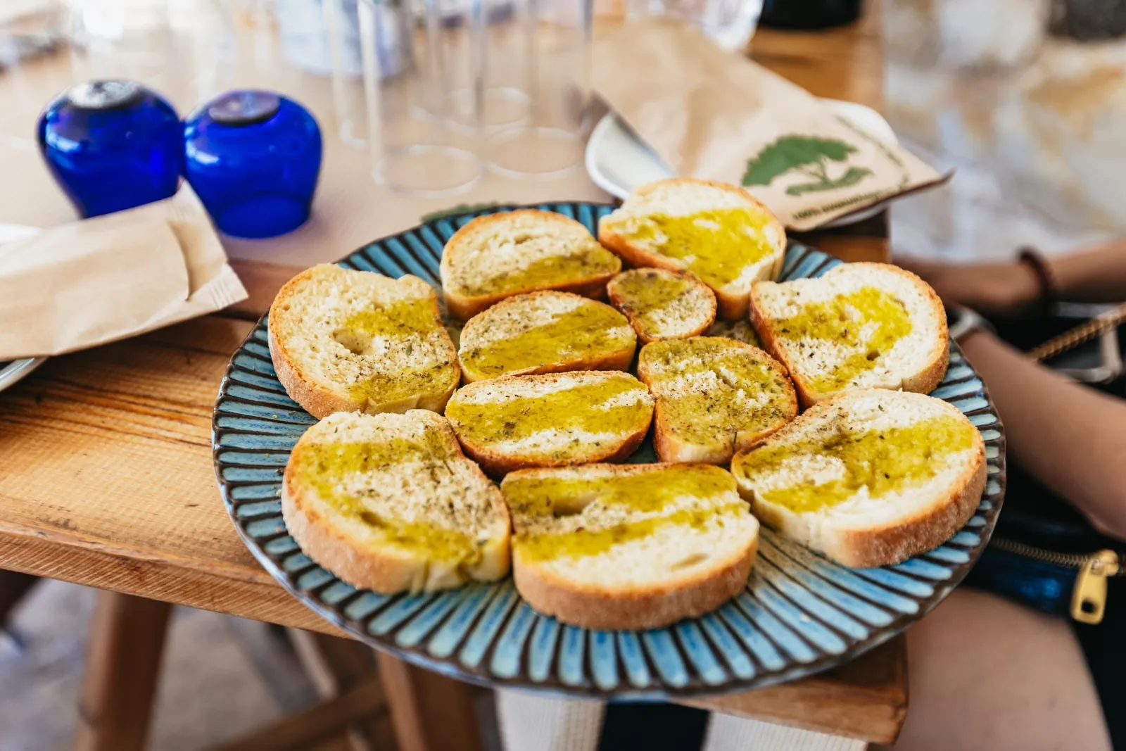 Rusks dressed with fresh olive oil, served with blue tasting glasses