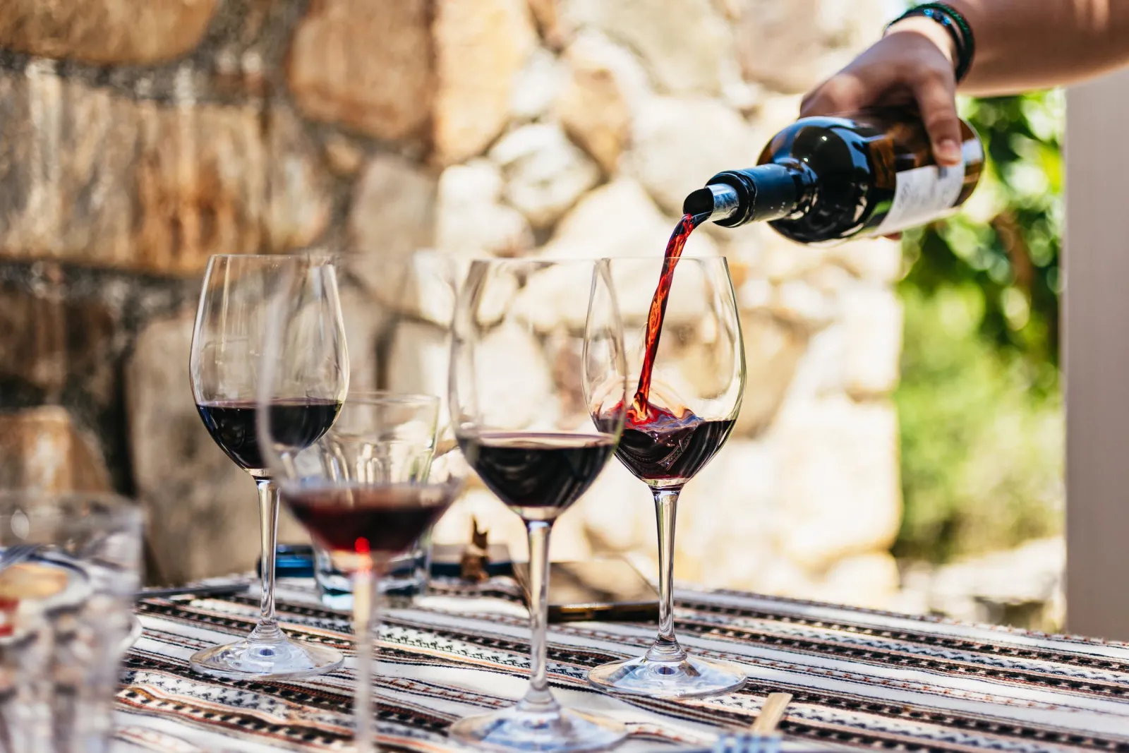Red wine poured into tasting glasses at the Kissamos winery